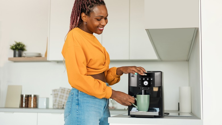 woman using coffee machine