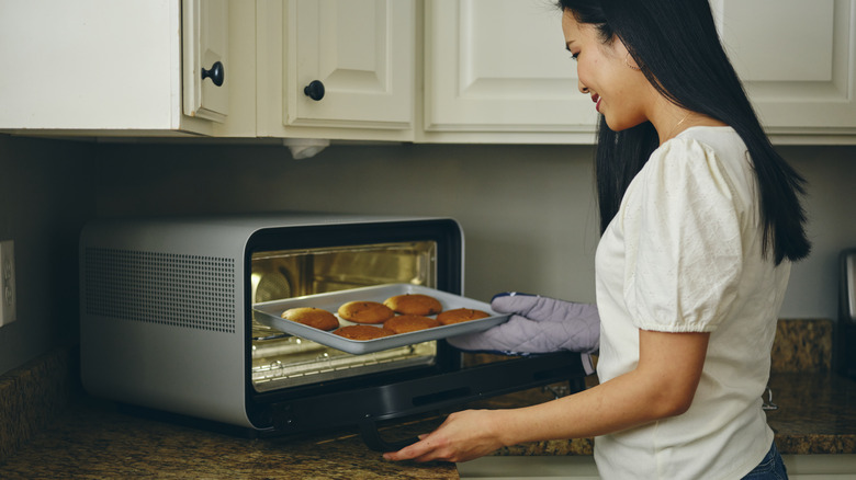 woman baking cookies in toaster oven