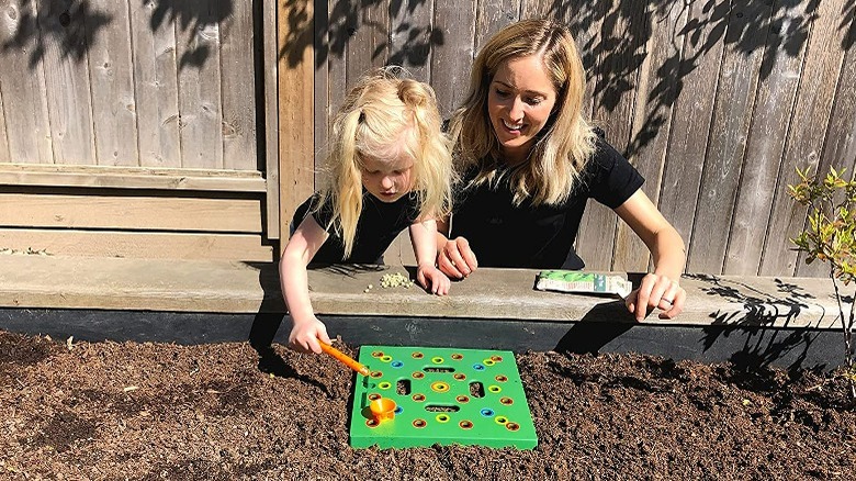 Child using square seeding template 