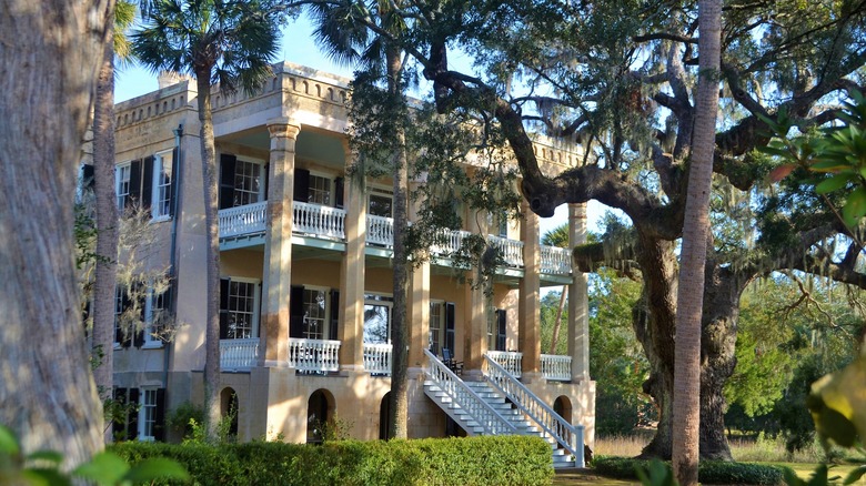 colonial home through the trees