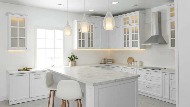 White kitchen with marble island