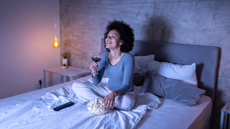 Woman watching tv in bed