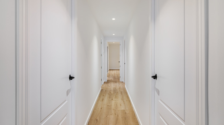 Long hallway with white walls