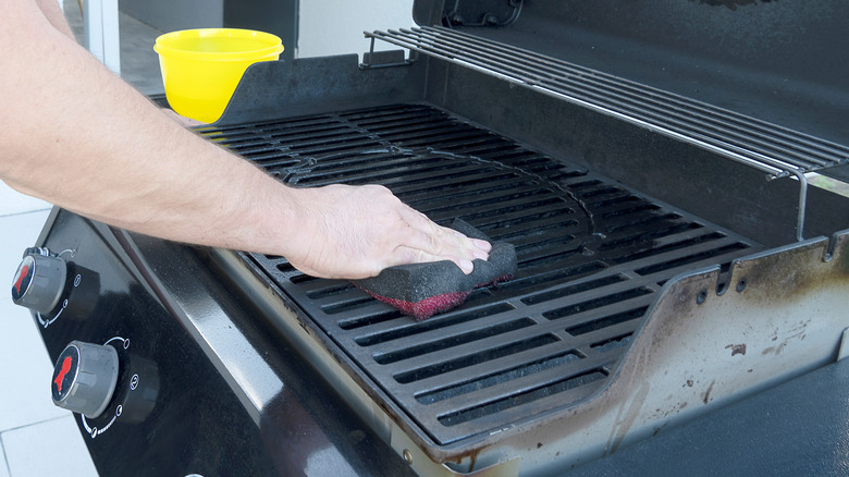 Cleaning outdoor grill with sponge