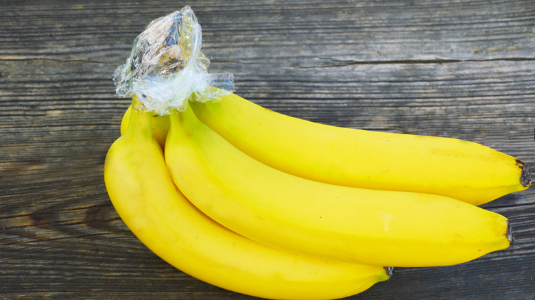 Bananas cover with plastic wrap