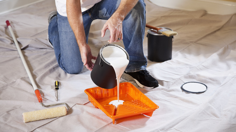 pouring paint into tray