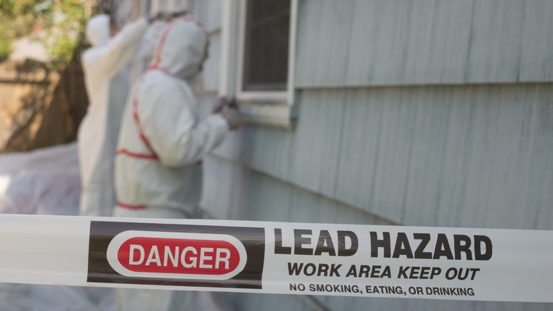Workers removing lead paint