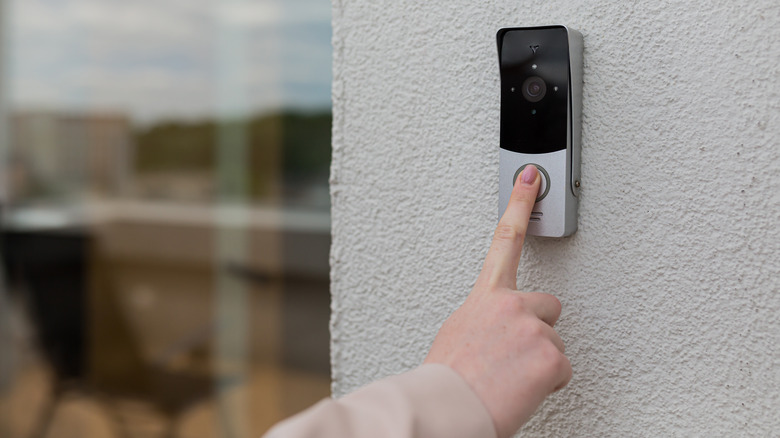 person ringing doorbell with camera