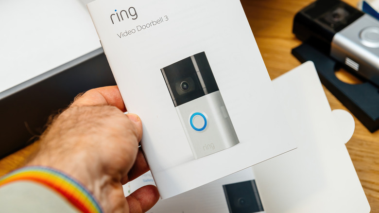 man reads Ring doorbell instructions