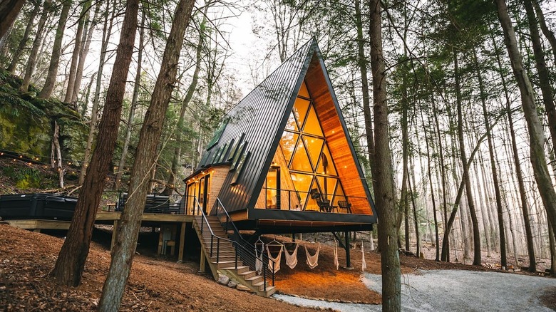 a frame cabin with geometric windows