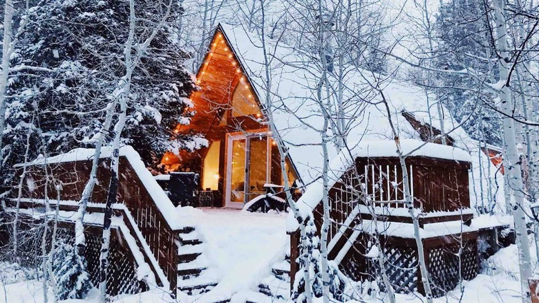 a frame cabin in snow