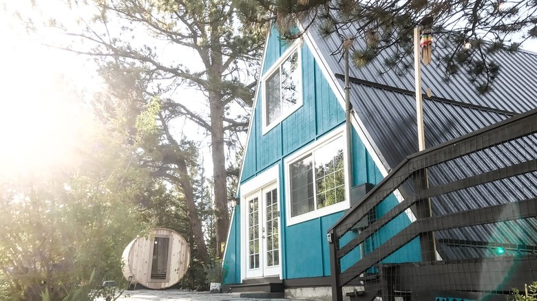 blue a frame cabin in woods