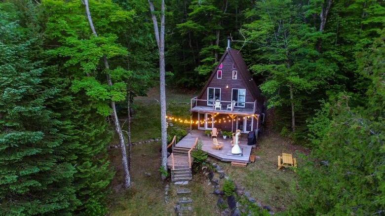 a frame cabin with string lights