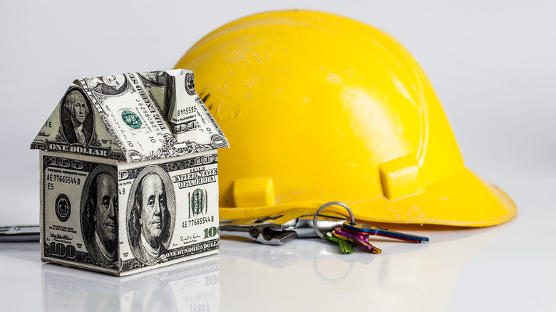 hard hat and house made of money