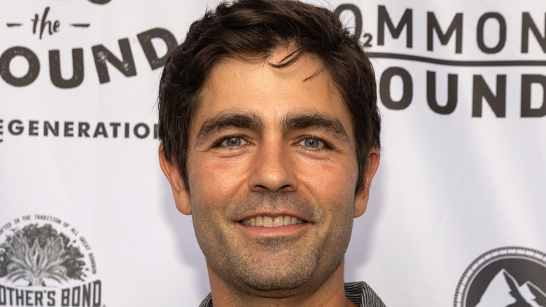 Adrian Grenier poses at film premiere