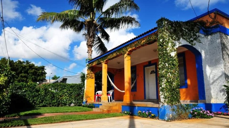 orange and blue house with vines