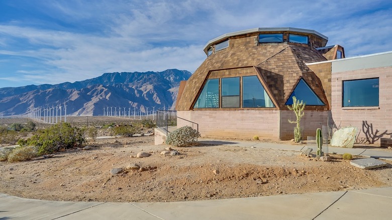 dome house in the desert wind mills 