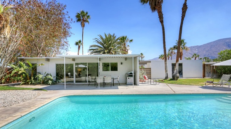 white house and patio with pool