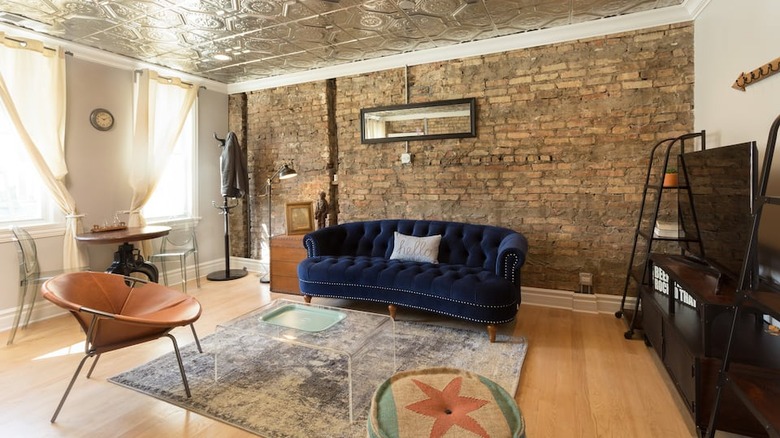 deep blue couch brick wall