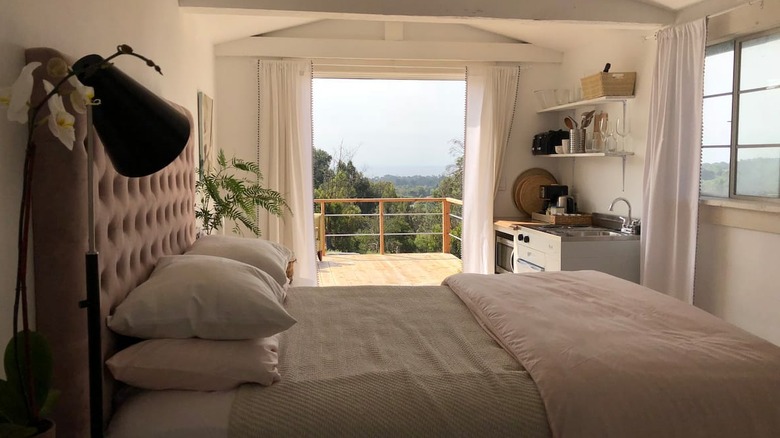 white bedroom with ocean balcony 