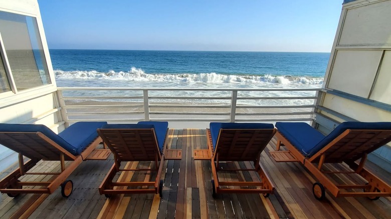 blue lounge chairs overlooking beach