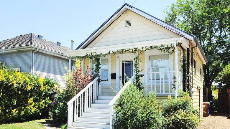 quaint yellow cottage with white steps