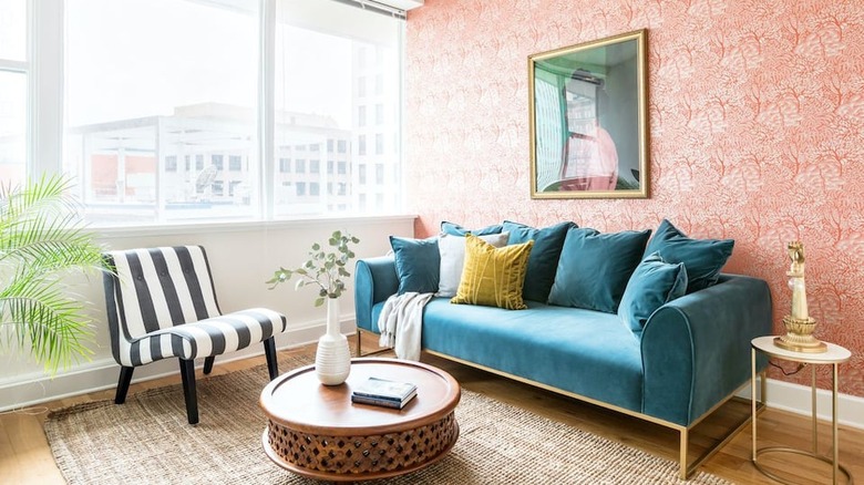 pink wallpaper and blue couch