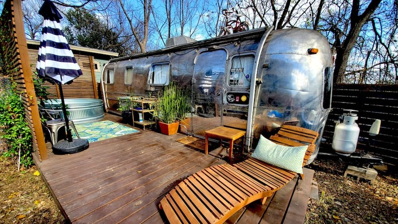 Airstream with cowboy tub and wooden deck