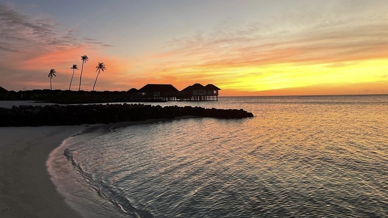 bungalows over water sunset