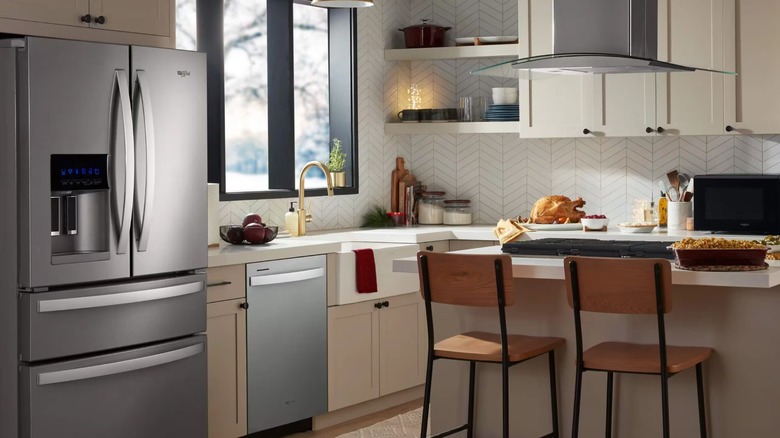 Whirlpool refrigerator and dishwasher in a modern kitchen