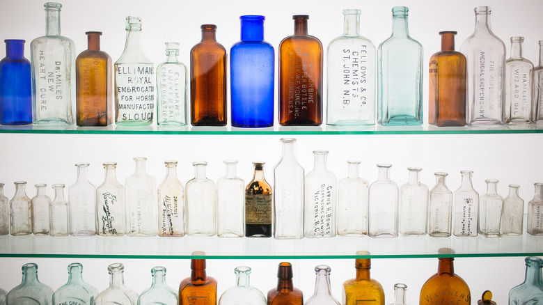 antique medicine bottles on shelves