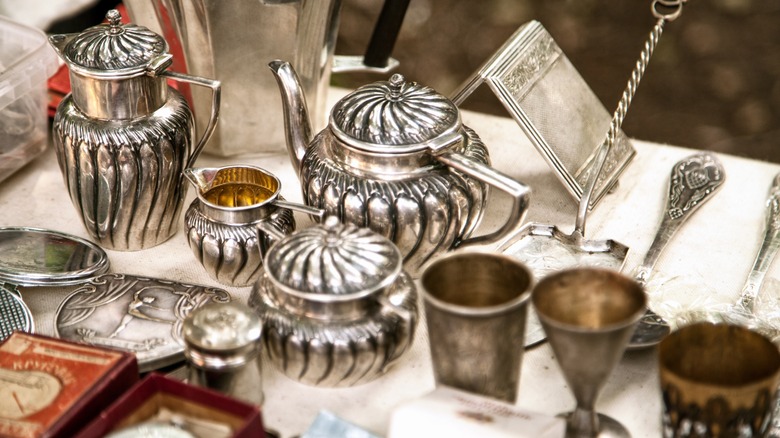 Antique silver serving items arranged on a table