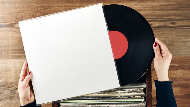 Person looking at a box of vinyl records