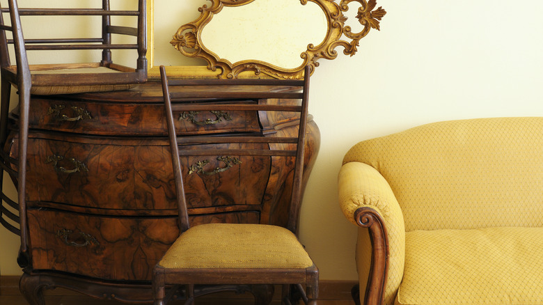 Antique dresser with gilt mirror and chair stacked on top