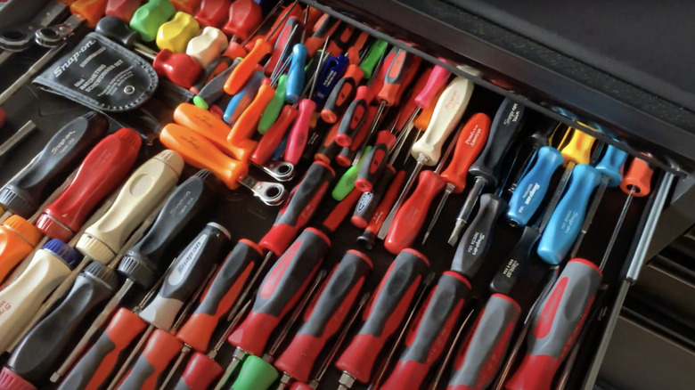 workbench drawer with assorted Snap-On screwdrivers