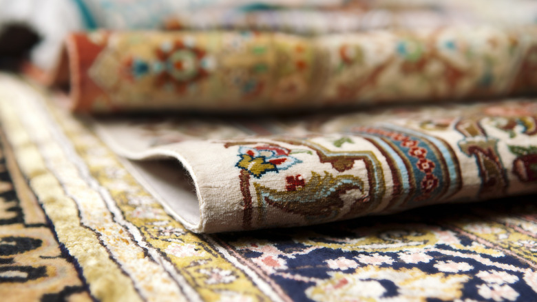 folded multicolored persian rugs