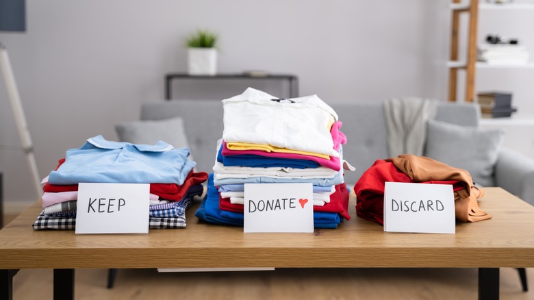 Keep, donate, discard clothes piles