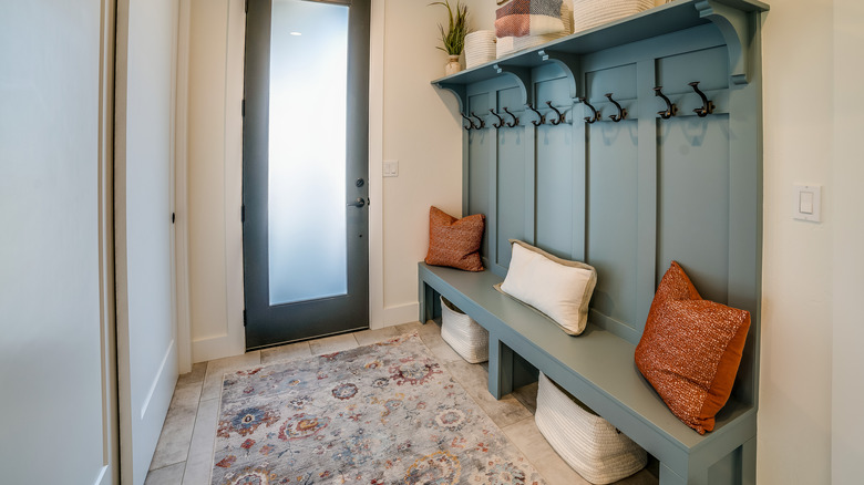 mudroom with rug over flooring