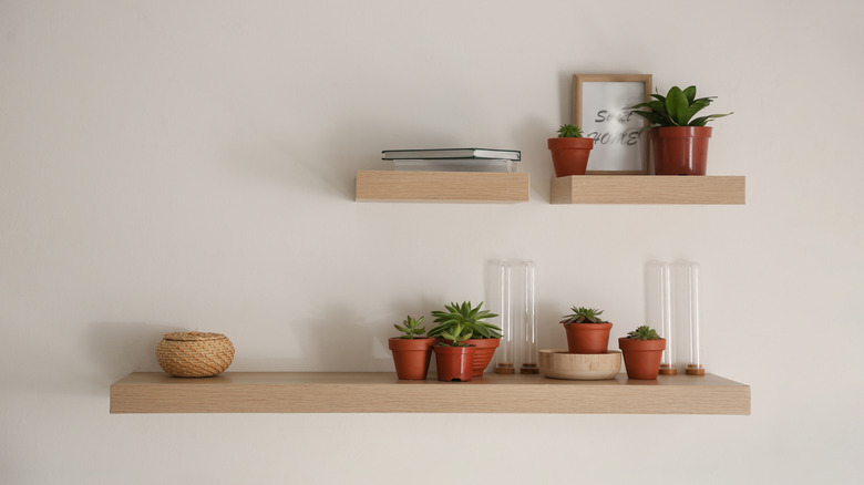 Wood shelves hang on wall