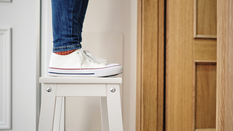 Person standing on a step ladder