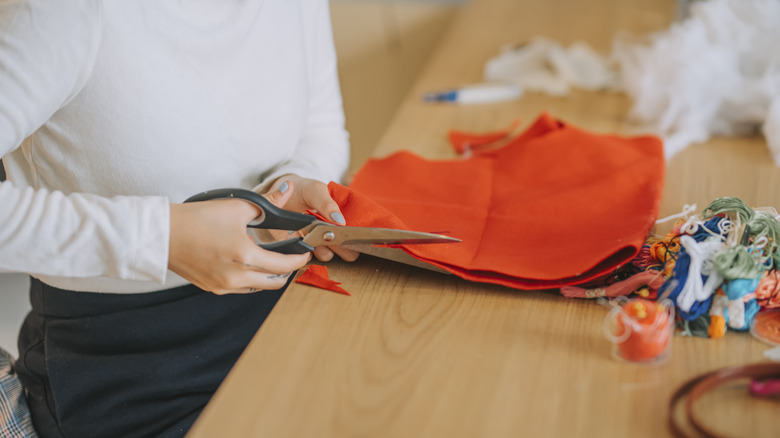 person cutting fabric for project