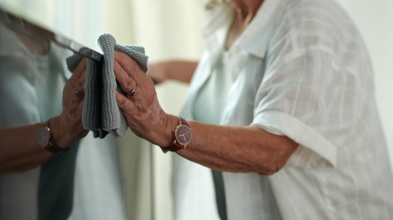 woman cleaning a TV screen