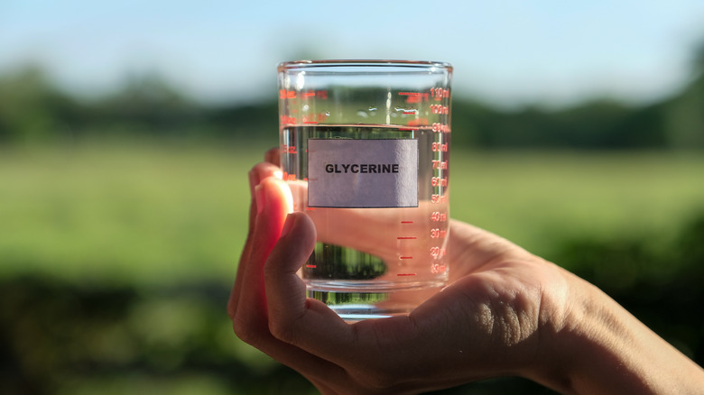 palm holding glass of glycerin