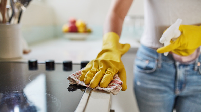 person cleaning kitchen counter