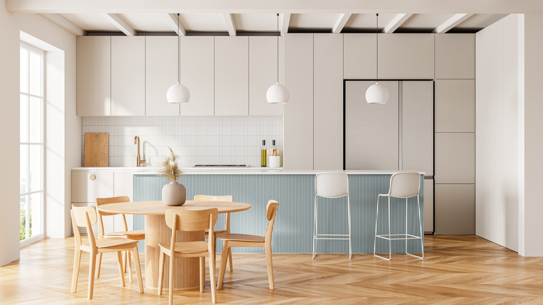 A contemporary white and blue kitchen with wood furniture.