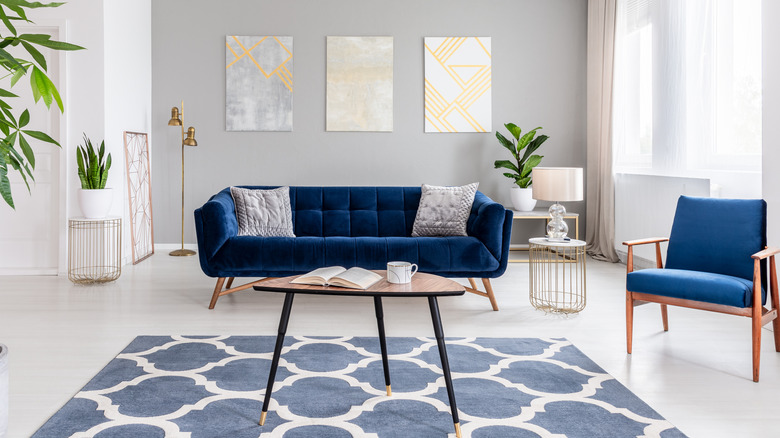 Gray wall with dark blue furniture