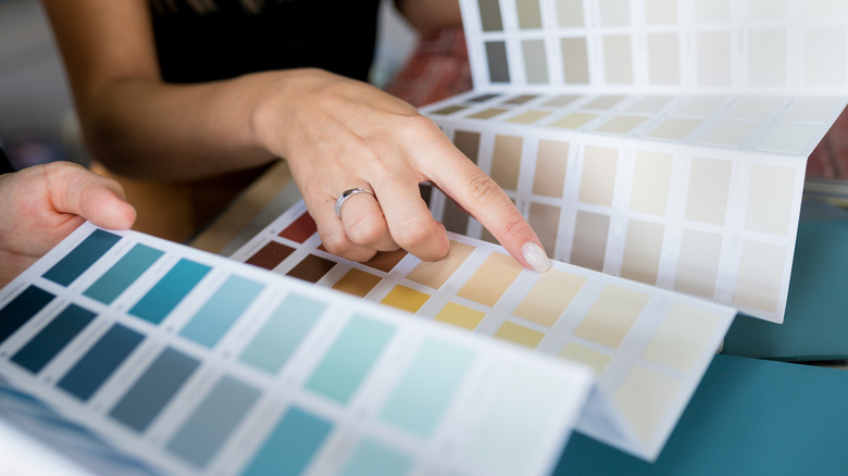 Woman pointing at paint color swatches