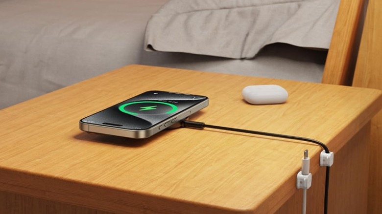 Magnetic cord clips attached to back of wooden nightstand