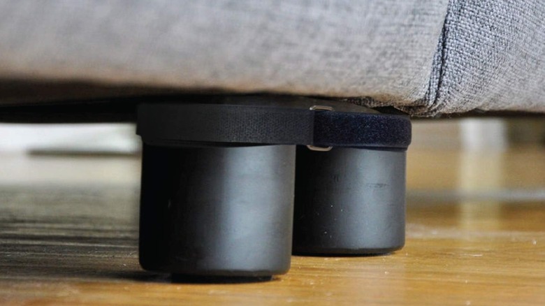 Couch Clamps being used on the legs of a gray sofa