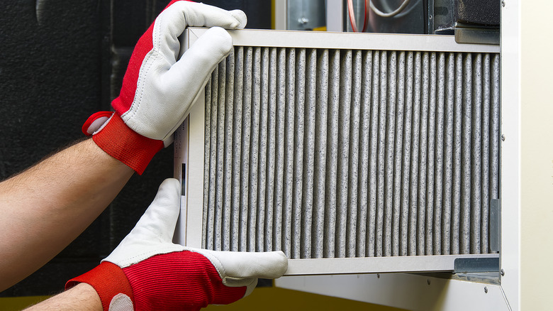 Hands replacing air filter